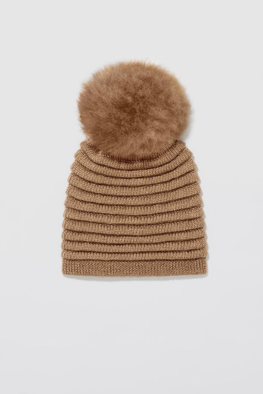 Sentaler Adult Ribbed Hat With Oversized Fur Pompon featured in Baby Alpaca and available in Dark Camel. Seen as off figure.