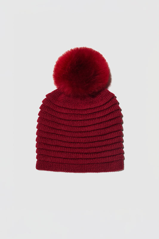 Sentaler Adult Ribbed Hat With Oversized Fur Pompon featured in Baby Alpaca and available in Garnet Red. Seen as off figure.
