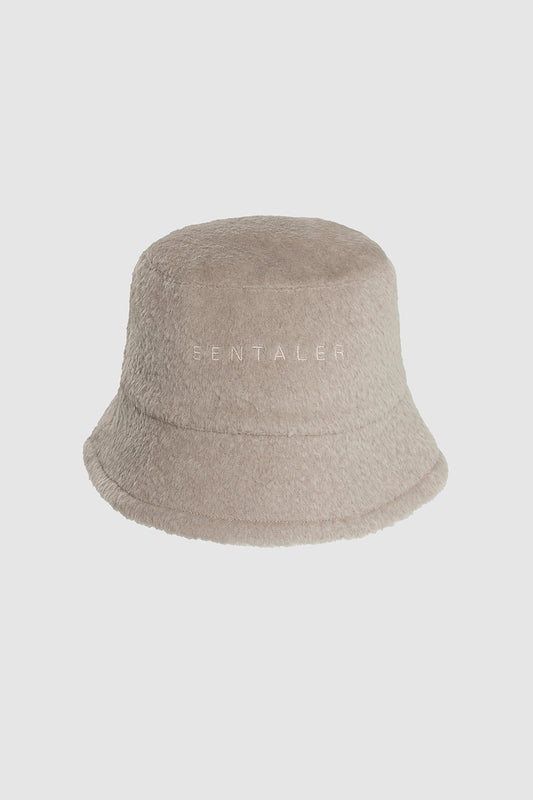 Sentaler Bouclé Alpaca Bucket Hat featured in Bouclé Alpaca and available in Sand Neutral. Seen as off figure.