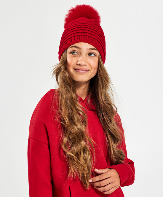 Sentaler Kids (6-14 Years) Ribbed Hat with Oversized Fur Pompon featured in Baby Alpaca and available in Red. Seen from front on model above the waist.