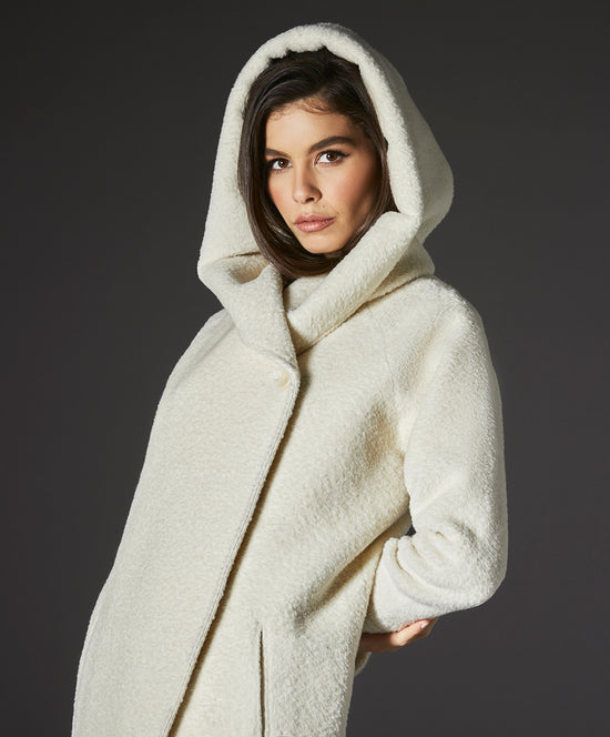 Sentaler Bouclé Alpaca Long Hooded Ivory Coat in Bouclé Alpaca wool. Seen from side close up on female model with hood.