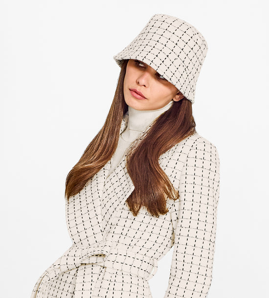 Sentaler Tweed Ivory Check Bucket Hat in Tweed Baby Alpaca wool. Seen from side close up on female model.